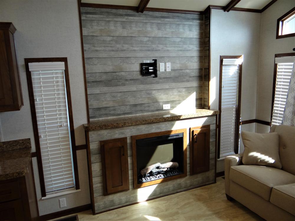Main Wall Panels in Cooper Cream with Knot Oak Accent Wall.   Optional Fireplace & TV Bracket