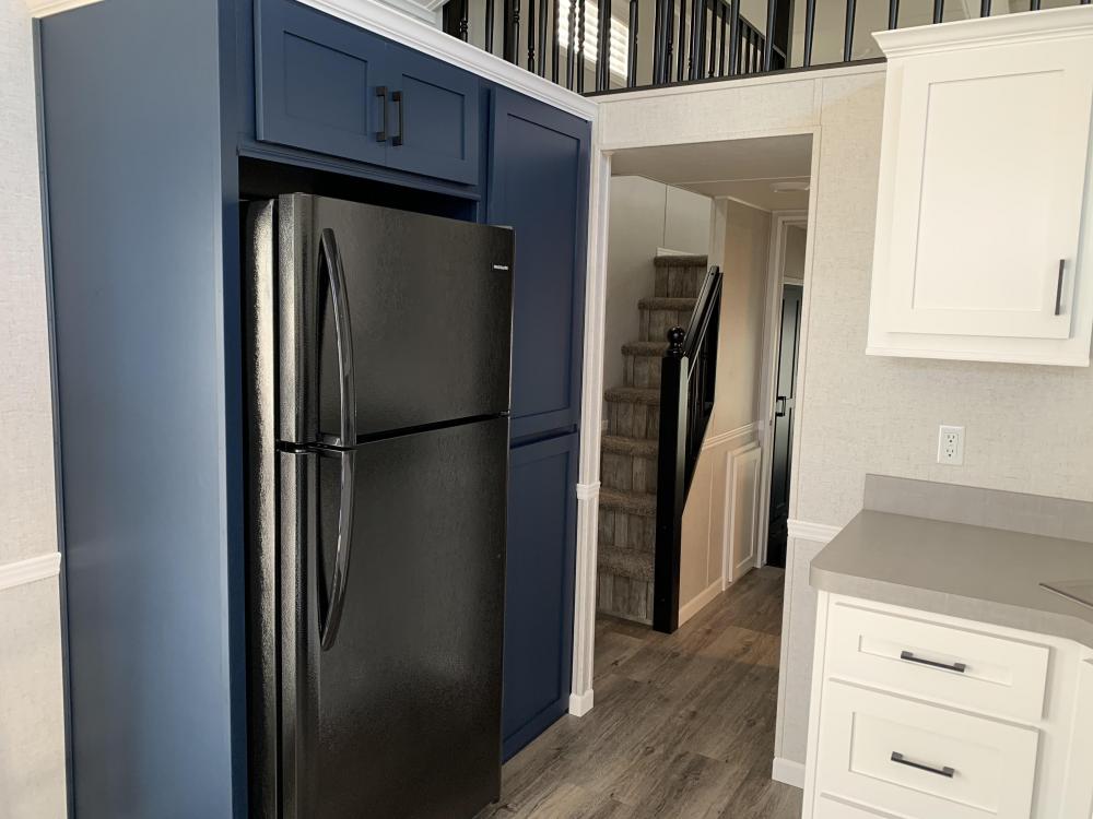 Navy Pantry & Overhead Frig Cabinets with Snow White Crown Molding & Standard Black Matte Handles 