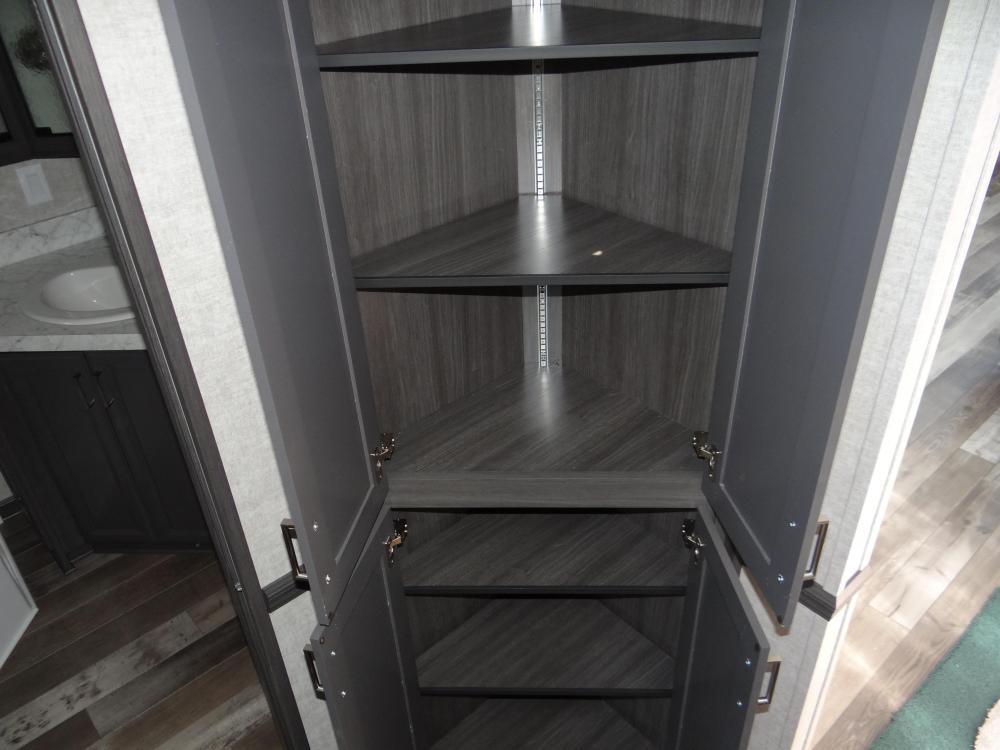 Corner Pantry with Adjustable Shelves in Hallway