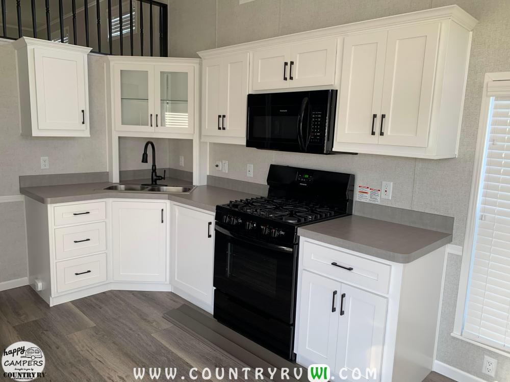 Snow White Cabinets in Kitchen & Living Room with Kopi Susu Colored Countertops 