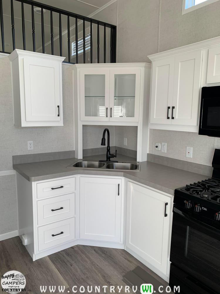 Standard Floorplan Changed - Kitchen to Removed Corner Cooktop with Euro Range & Sub Sink with Corner Glass Cabinet